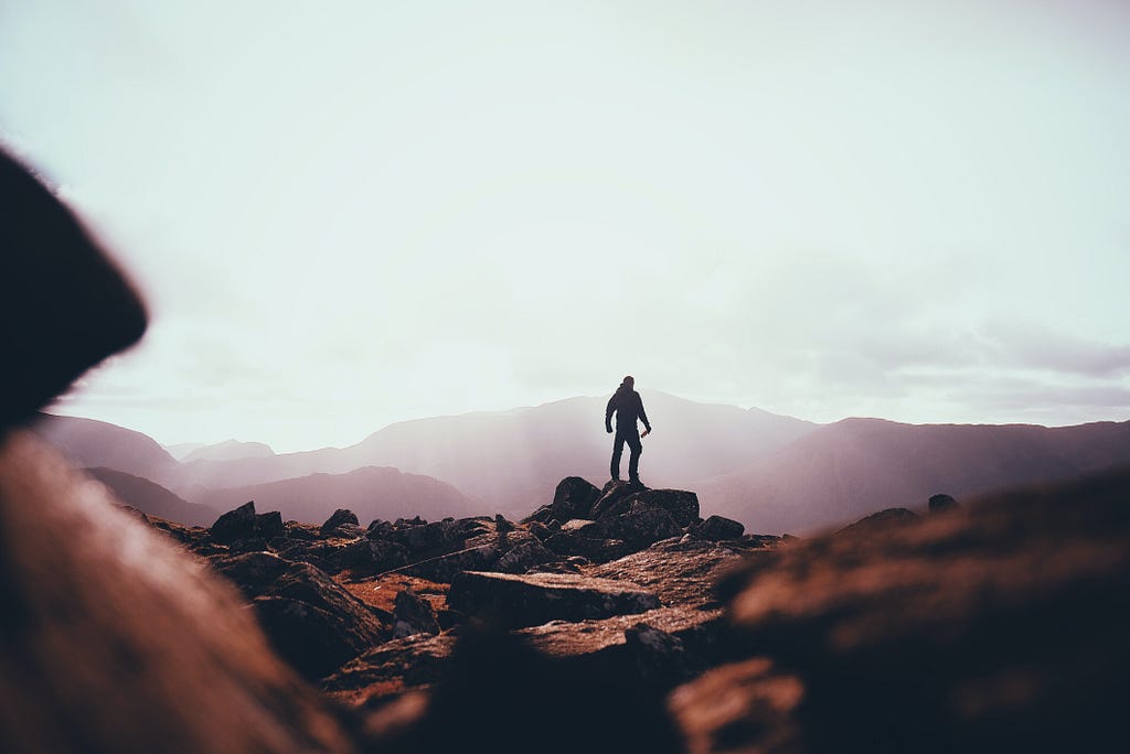 Person standing on huge rock