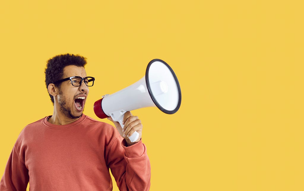 Man shouting in megaphone.