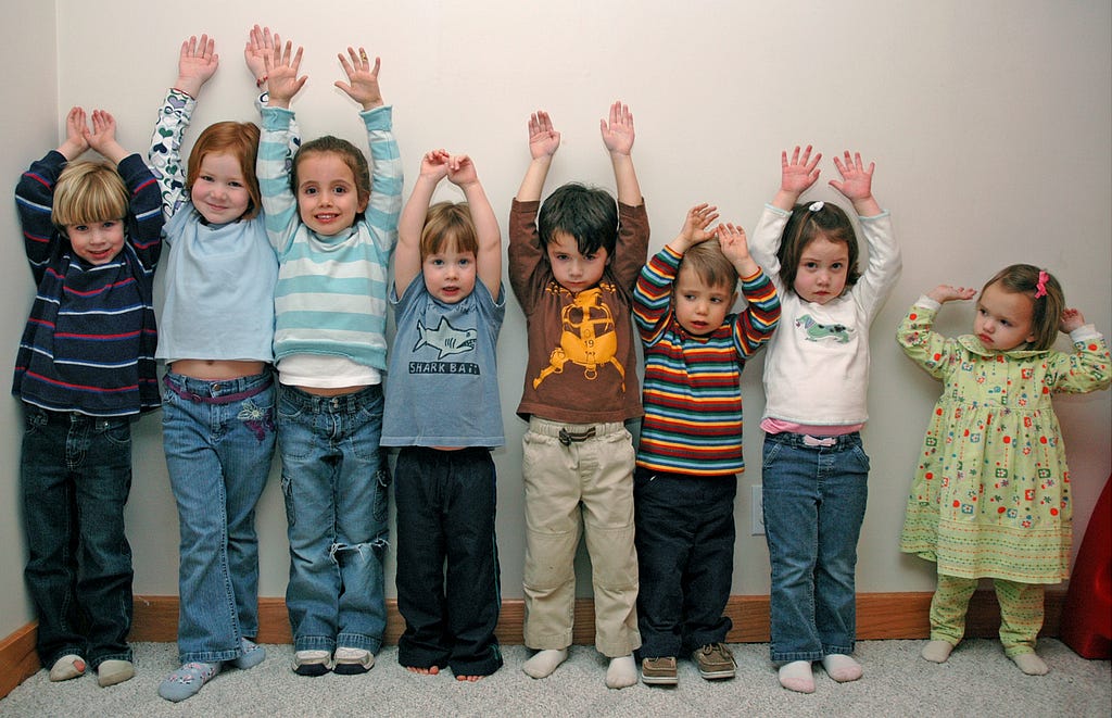 Photo of Justice Alito’s grandchildren in a police lineup wth their hands raised.