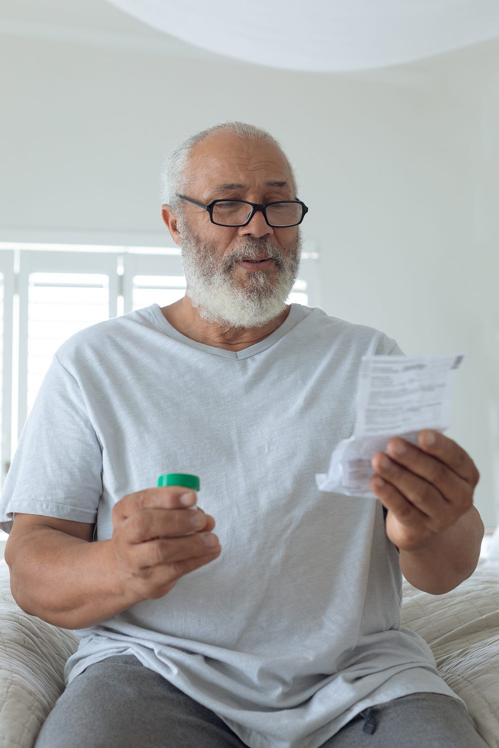 Old man looking through prescriptions