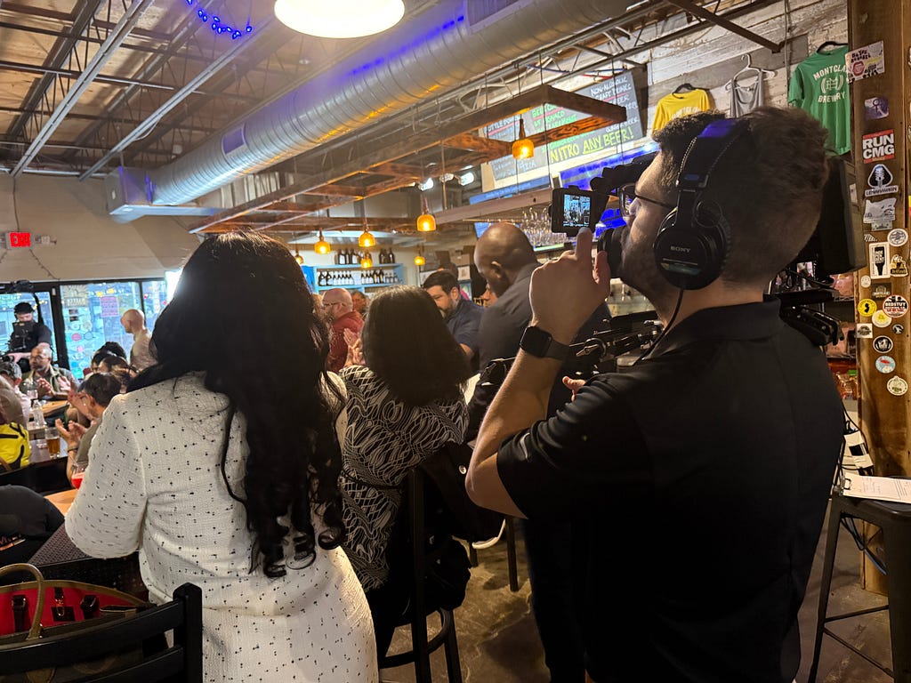 A Fuerza Strategy Group videographer films a political campaign event in Montclair, New Jersey.