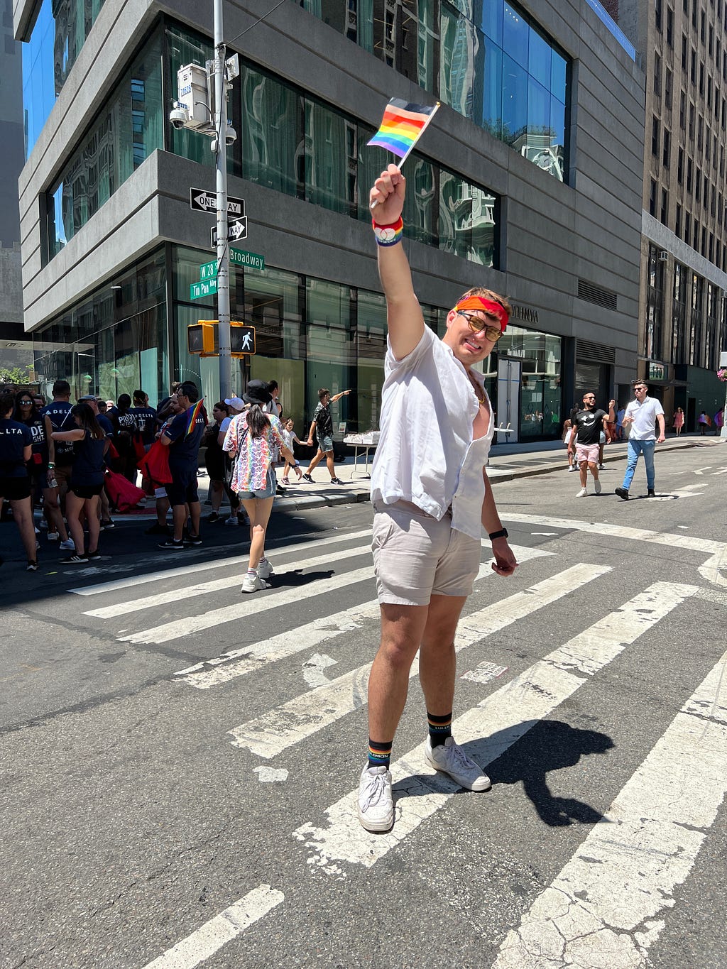 Reid holding a hand-sized pride flag at his first ever pride in NYC in 2022