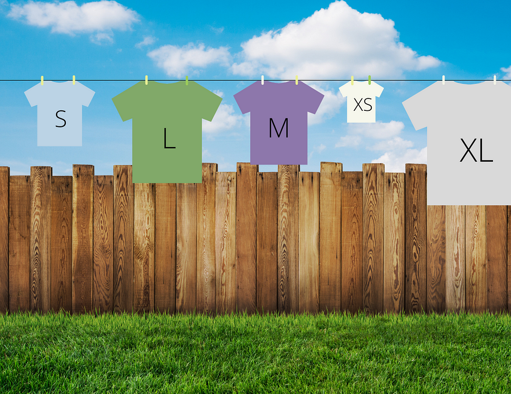 A garden with a wooden fence and blue sky with clouds. A washing line is hanging with five t-shirts. On the front of t-shirts is their size; XS, S, M, L and XL.