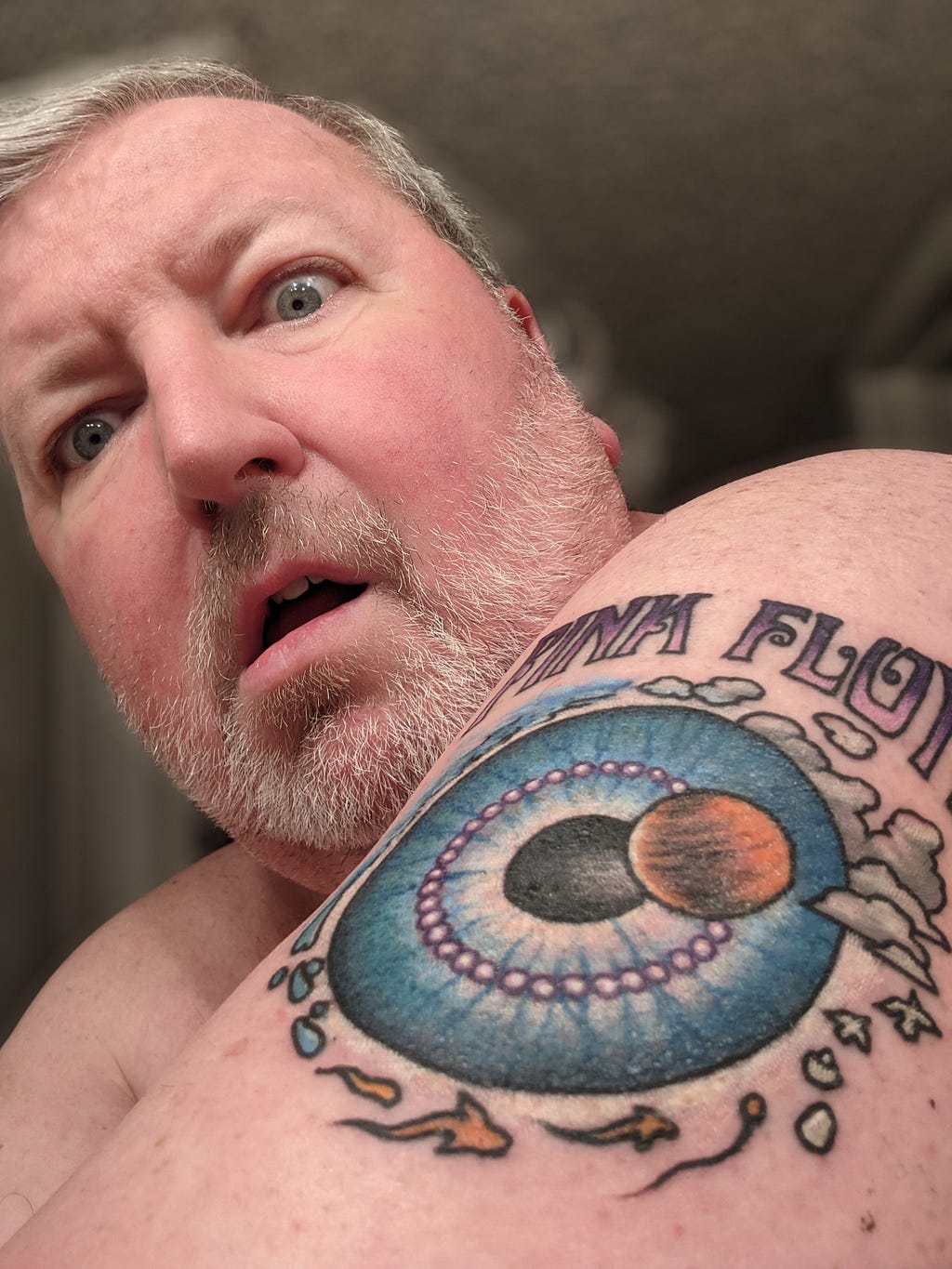 Author self portrait with Pink Floyd tattoo on shoulder