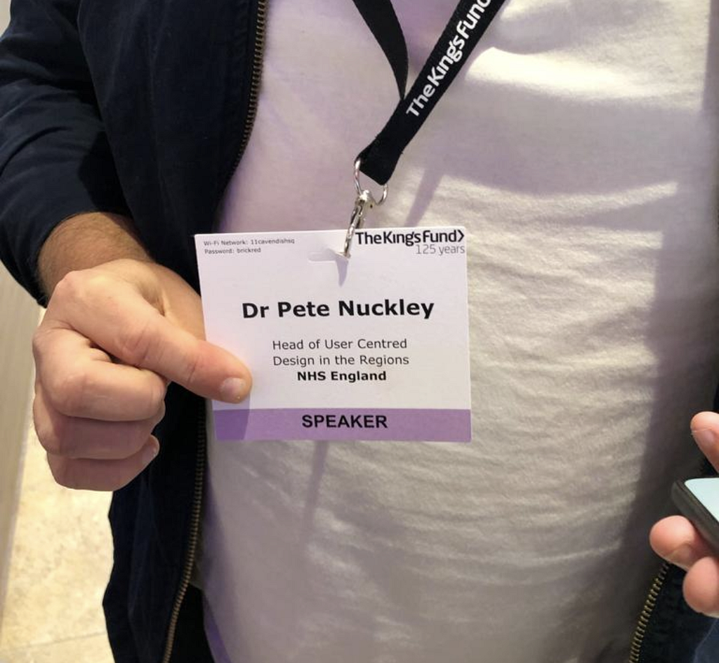 A picture of me holding a name badge that says ‘Dr Pete Nuckley’