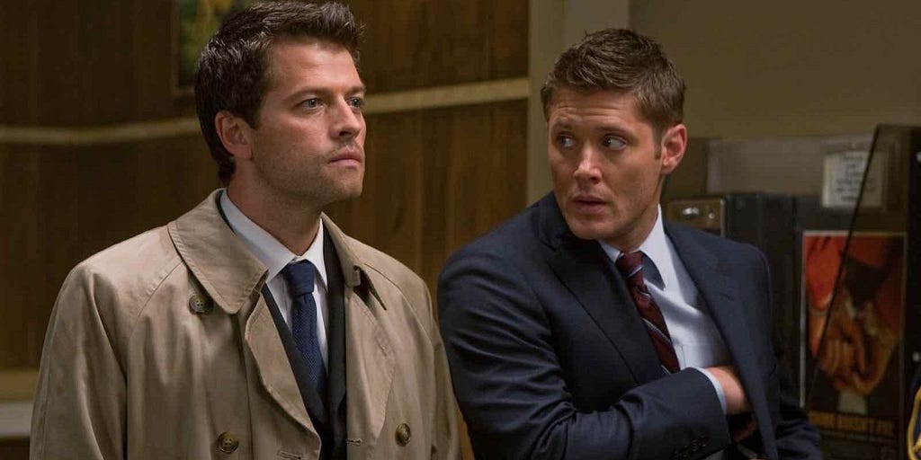 A screen-grab of Supernatural, wherein Dean on the right of the image looks at Castiel, on the left