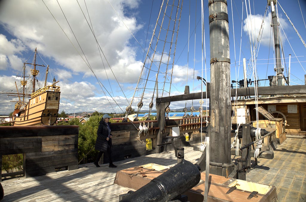 The stern of the replica Victoria can be seen from the deck of another vessel.