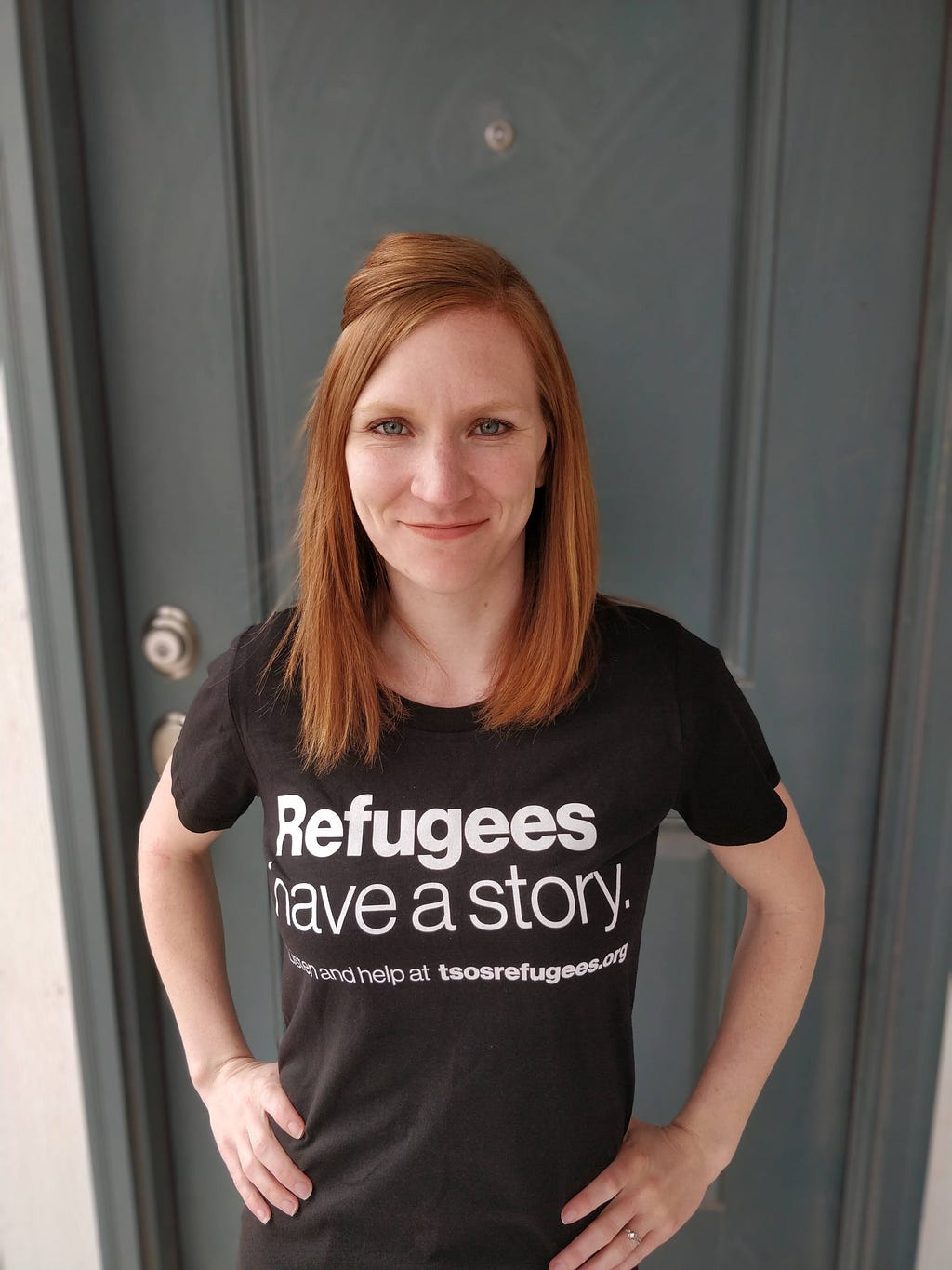Veronika wearing a black shirt with white letters that read, “Refugees have a story.