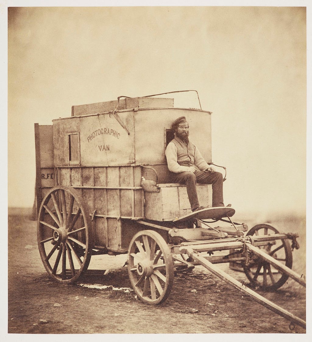 Roger Fenton’s sepia tone portrait of Marcus Sparling seated on their photographic van during the Crimean war