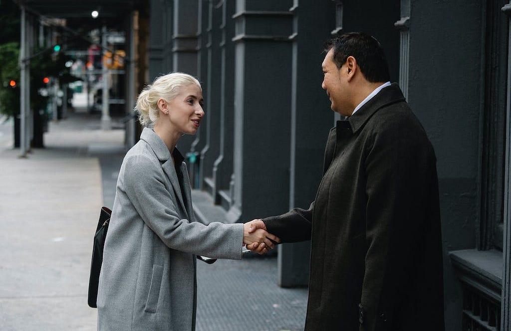 business man and business woman handshake