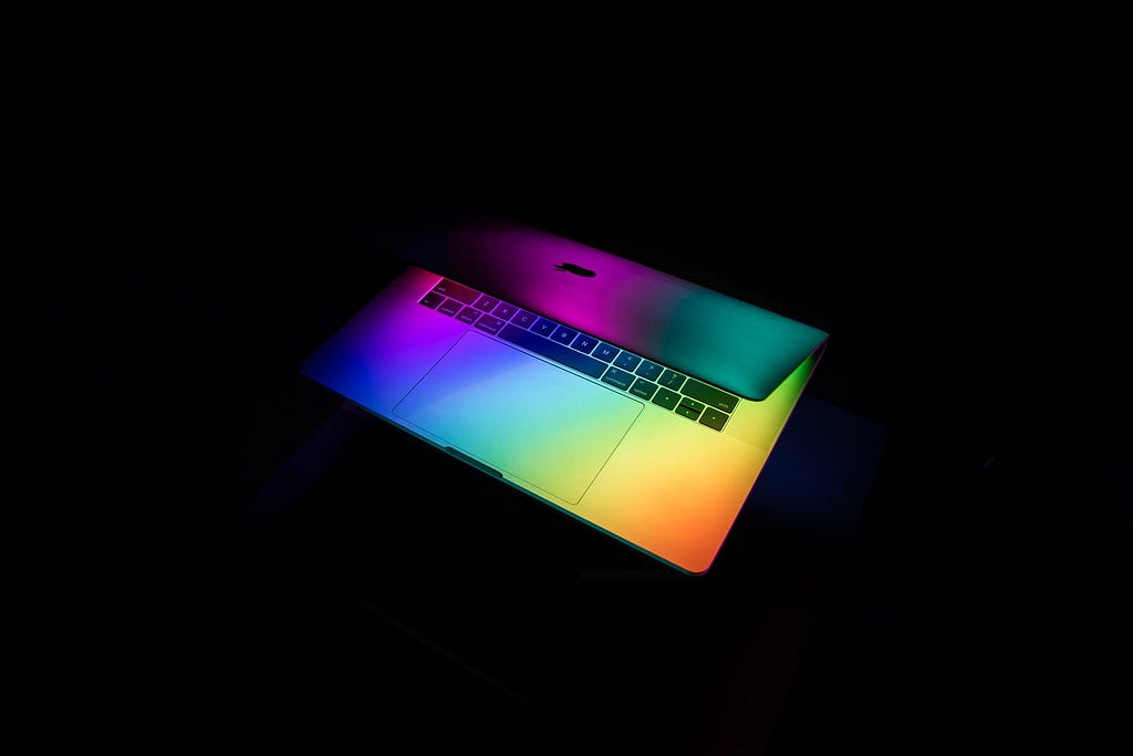 A laptop with rainbow colors highlighting it.
