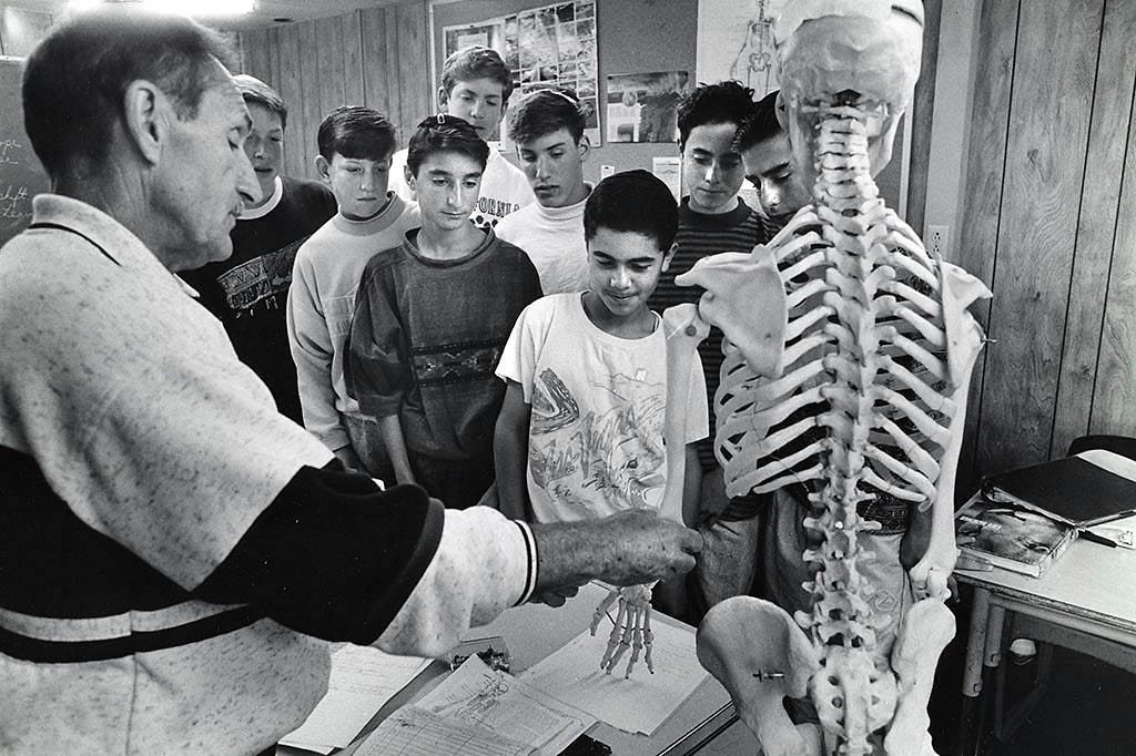 With students and teacher as actors, and a prop ready, the photographer directs (Judah S. Harris)