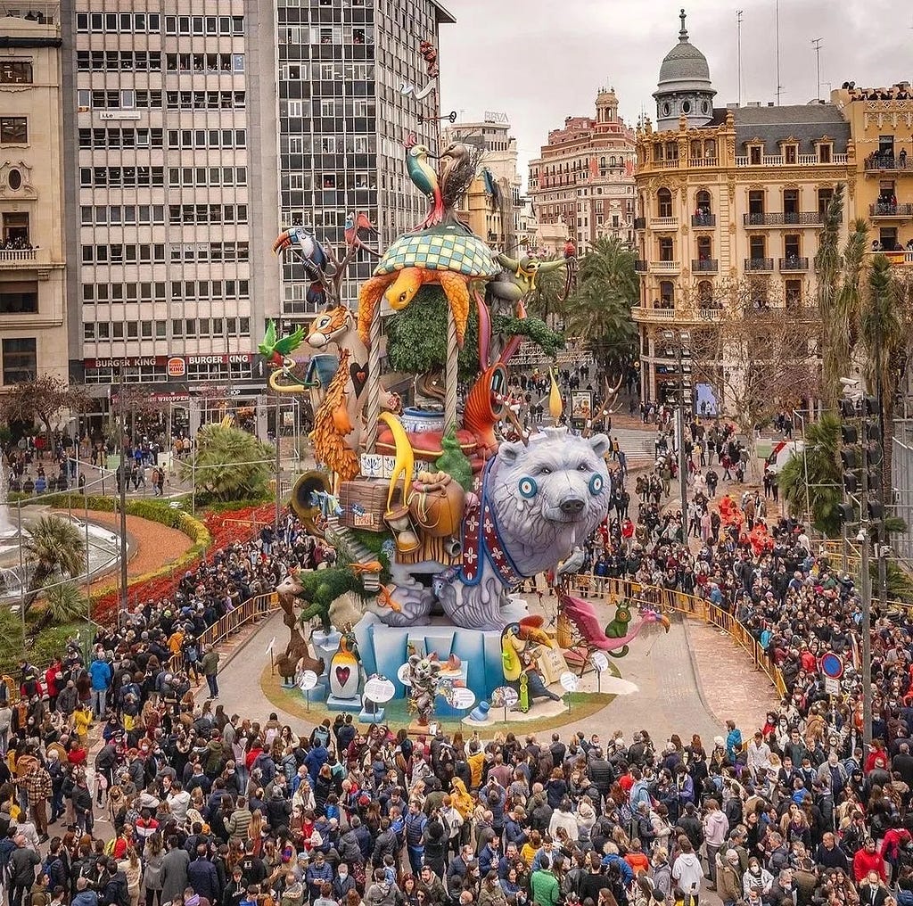 A sculpture for Las Fallas and a crowd of people in the city center