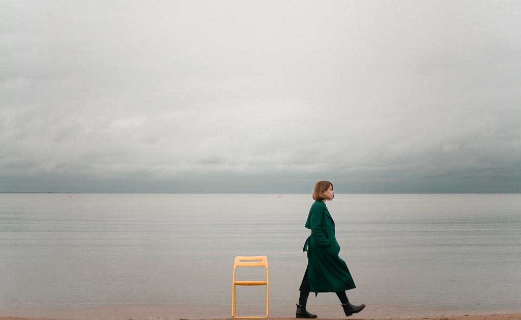 Woman walking on beach alone