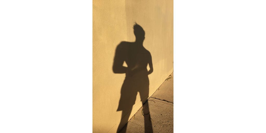 Shadow of adolescence against a wall
