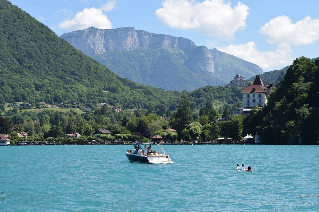 A water-skier waits behind an idling boat in Lake Annecy.