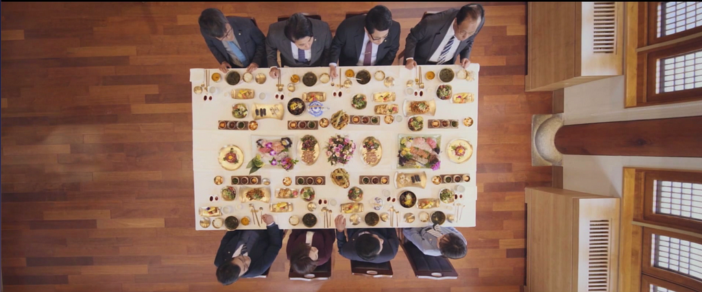 Overhead shot of a table with eight traditional Korean place settings.