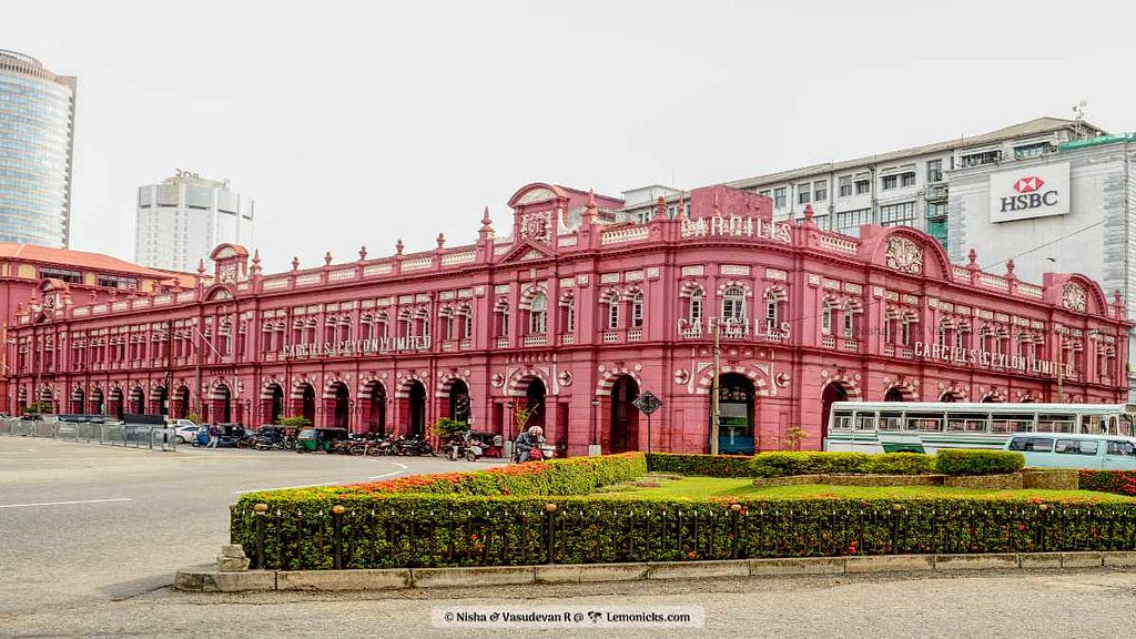 “The distinctive Cargills Building in Colombo, showcasing its colonial architecture with arched windows and ornate detailing against a clear blue sky.”