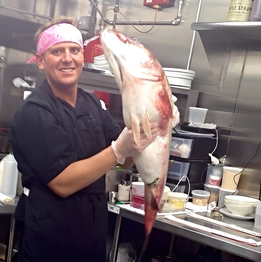 Chef Joe Nilsen holding a Red Snapper fish