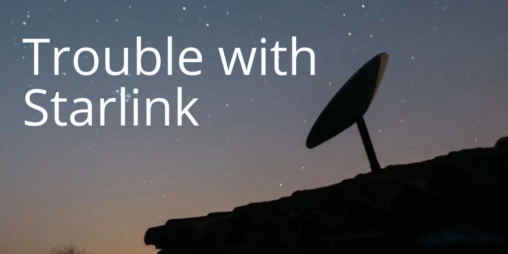 Starlink satellite dish, at night with starlit sky