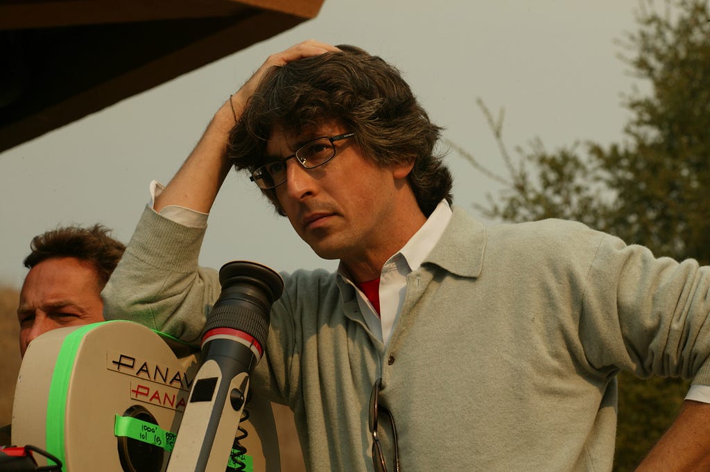 Alexander standing behind a camera on set