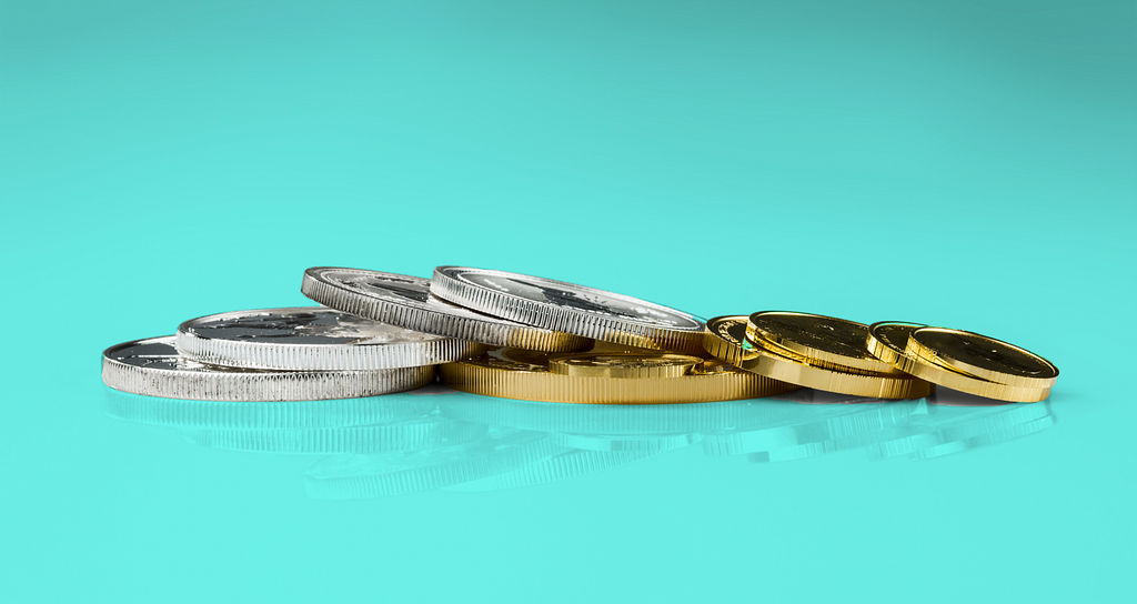 Several coins. Some of the coins are colored silver, some are colored gold.