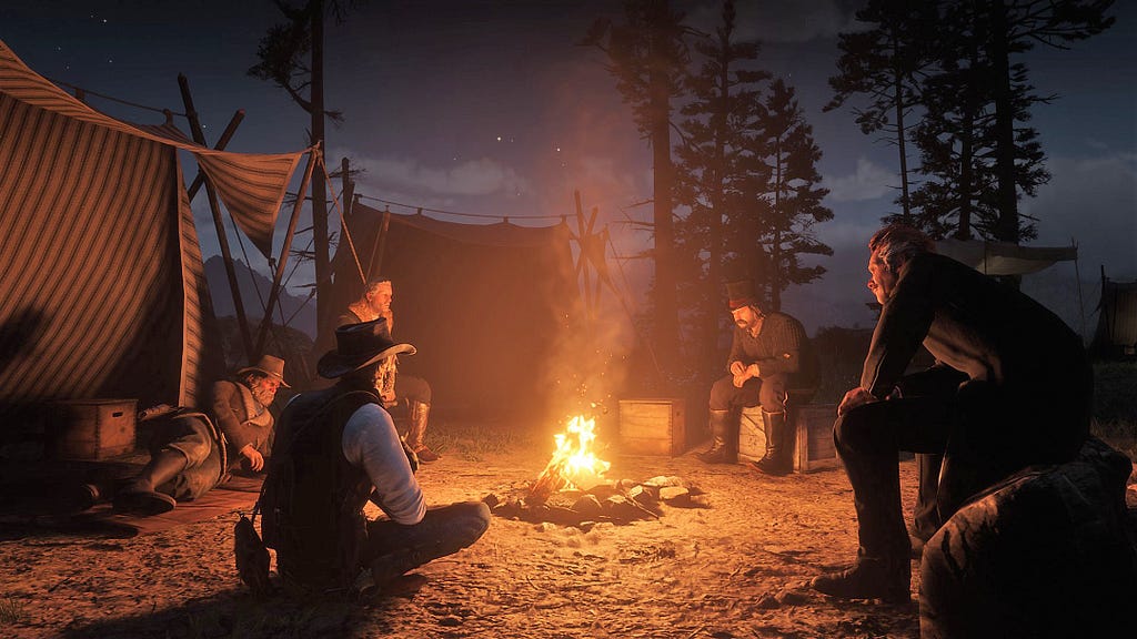 Arthur and the gang members huddling around the campfire