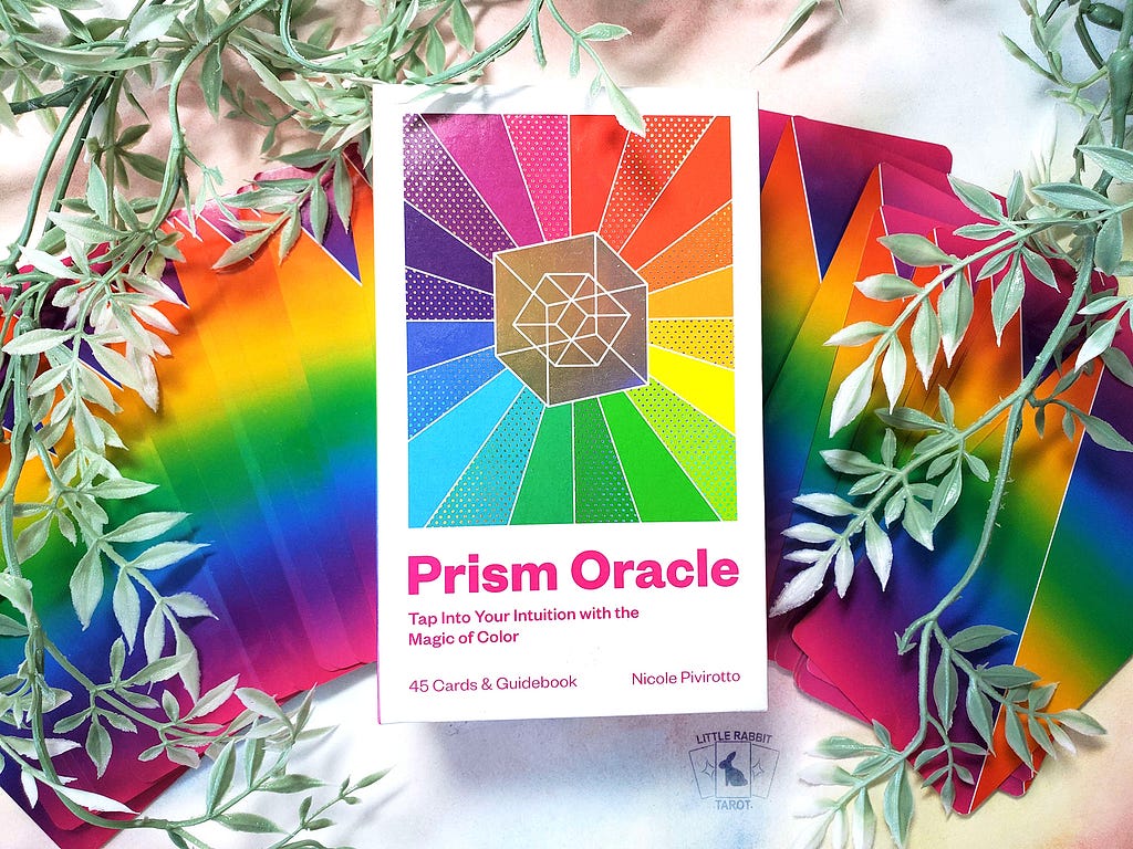 A photo of the oracle deck Prism Oracle, a rainbow themed deck.