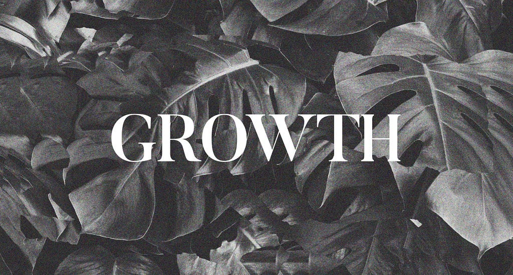 Black and white picture of plant leaves with the word “Growth” written across it.