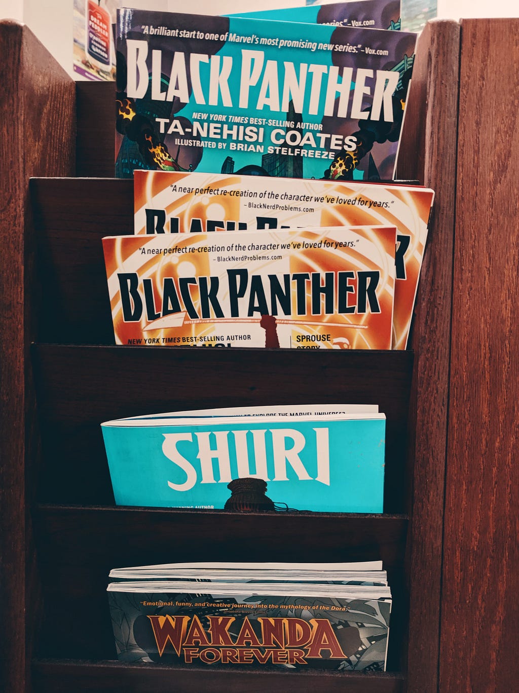 Photo of a collection of Black Panther Marvel comic books in a case on a wall