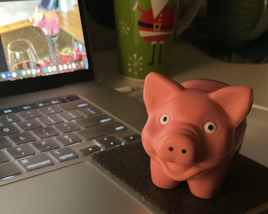 pig in front of laptop with another pig on the screen