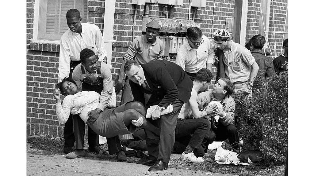 Civil rights activists in Selma tending to two injured comrades in 1965.