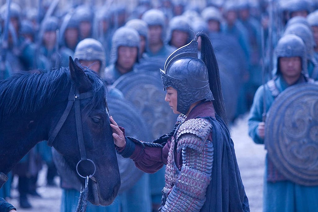We see Mulan, in the 2009 live-action version, petting her horse’s head while she wears an armor.