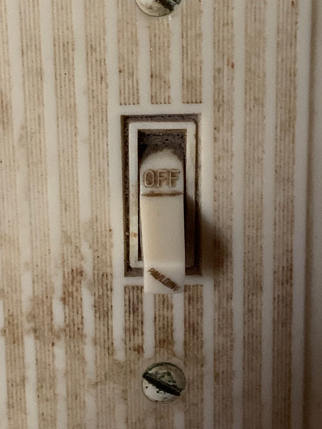 A light switch flipped to the “OFF” position.