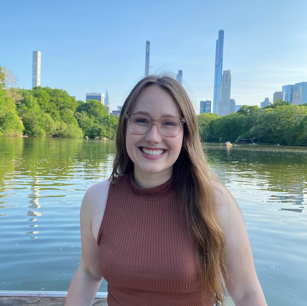 A picture of Microsoft Program Manager, Natalie smiling in front of a lake outside.