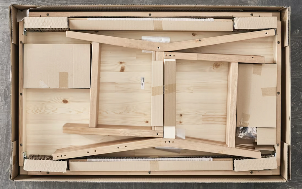 Image of an IKEA flat-pack furniture box, emphasizing the compact, well-designed packaging that represents economical and efficient use of resources.