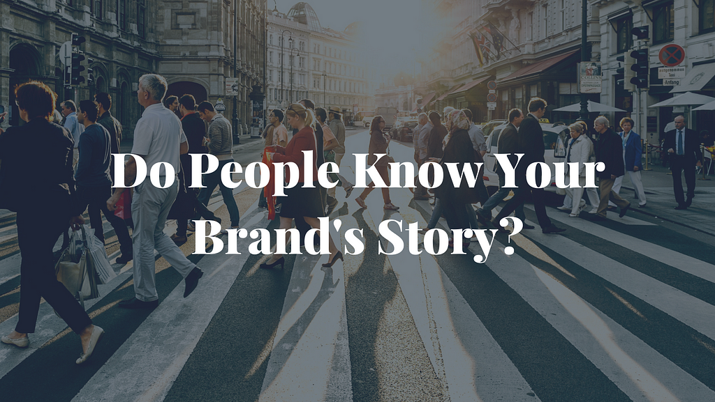 The question “Do People Know Your Brand’s Story” on top of an image of a crowd people walking across a crosswalk at sunrise in a city