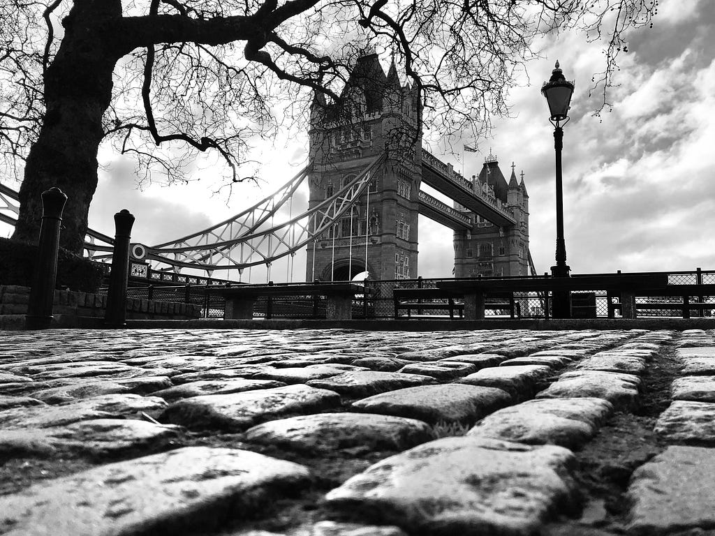 image of a bridge in london in black and white taken very low to the ground