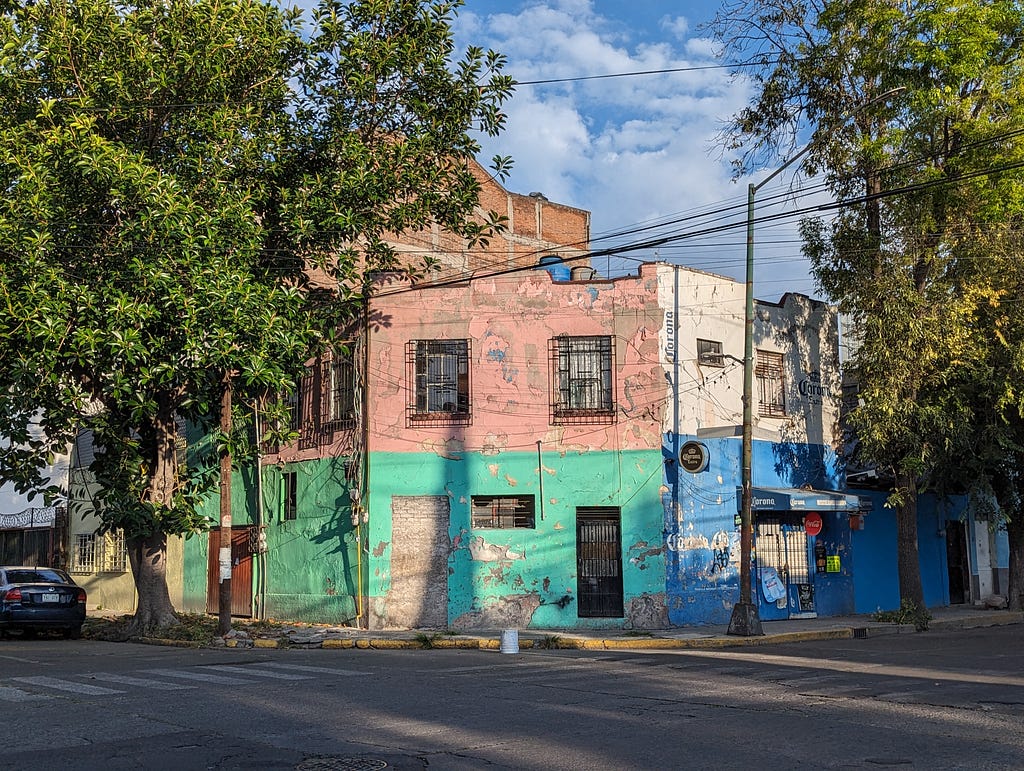 A building painted in different colours. On any given street in Mexico City it is not uncommon to come across brightly coloured buildings like this one.