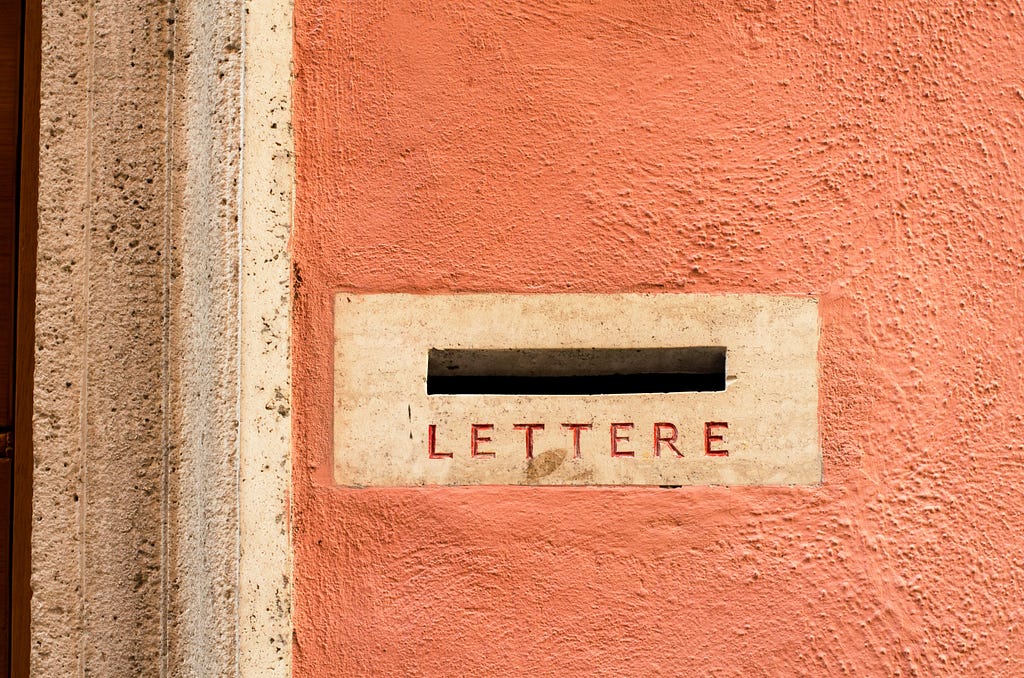 A European-style mail slot with the label “LETTERE”