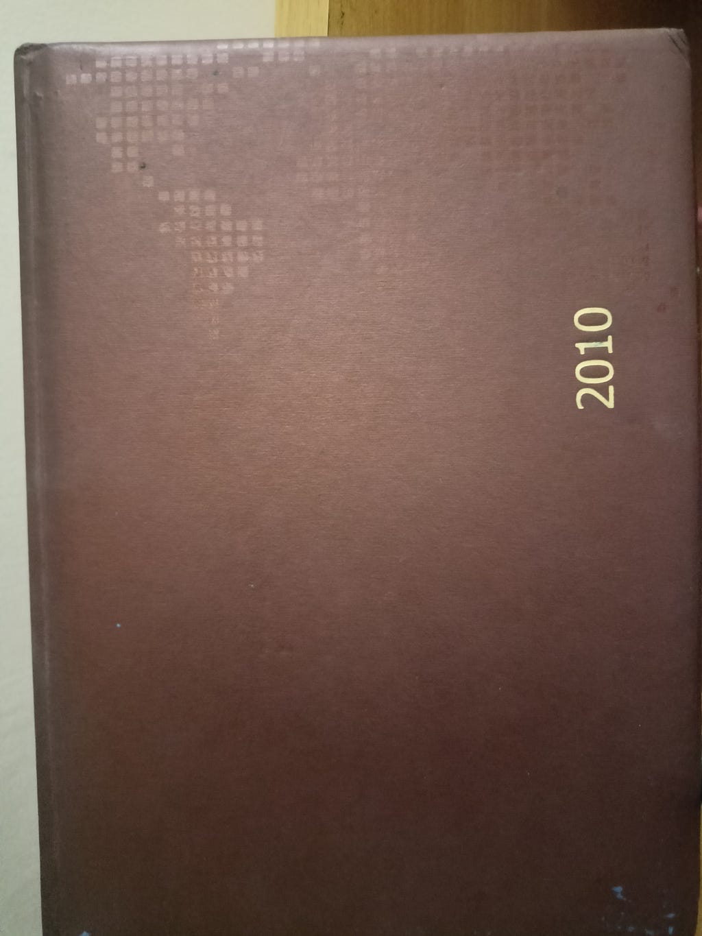 A hard bound diary with 2010 printed on the cover page.