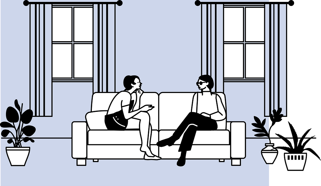 Two people sitting on a sofa talking to each other