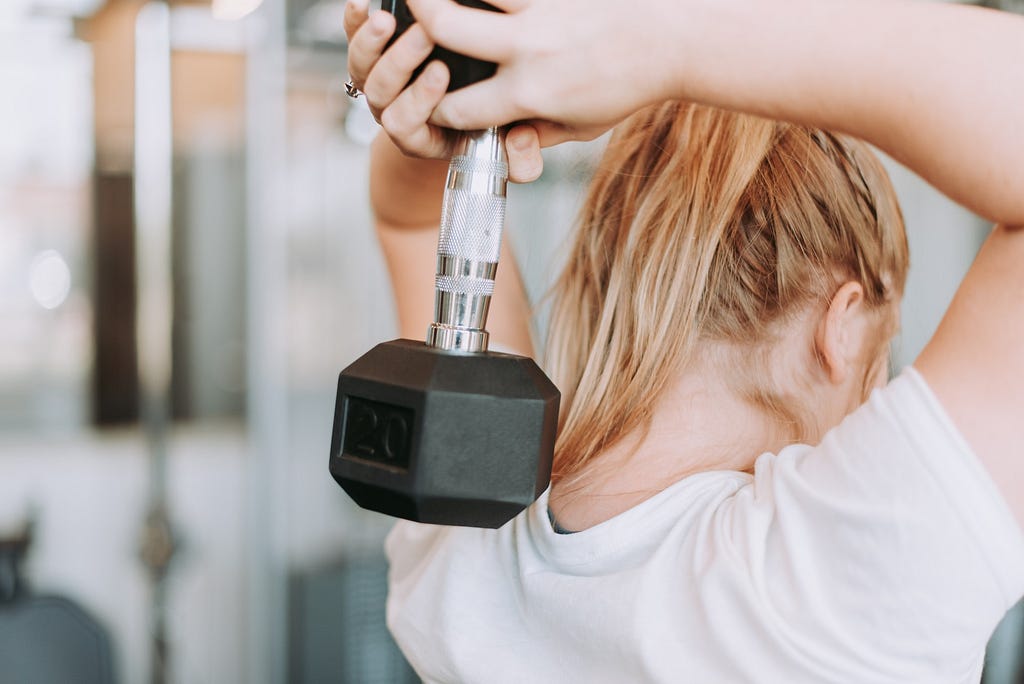 woman holding a dumbbell