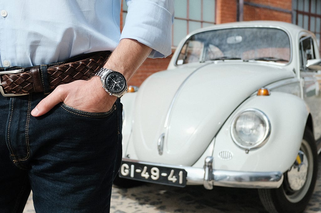 Pocket shot of the Omega Speedmaster with Bruno’s Volkswagen Beetle on the background