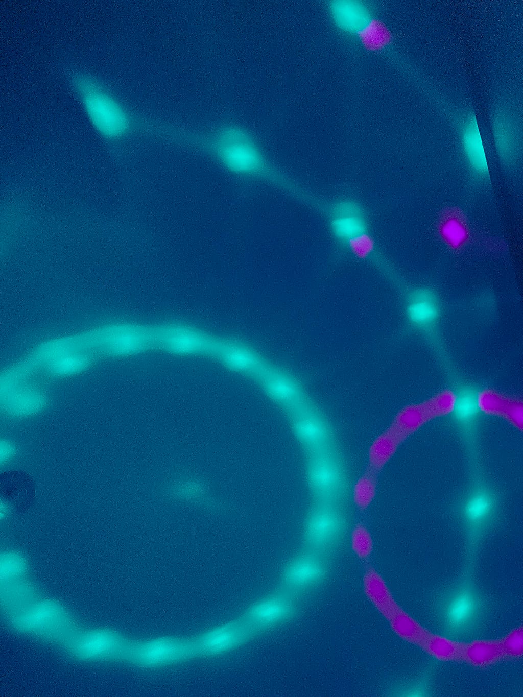 Circular light patterns flashing onto the celing in blue and purple, corresponding to the main colors from the single the poem took inspiration from.