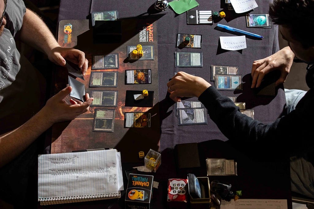 An overhead photo of two people playing Magic: The Gathering