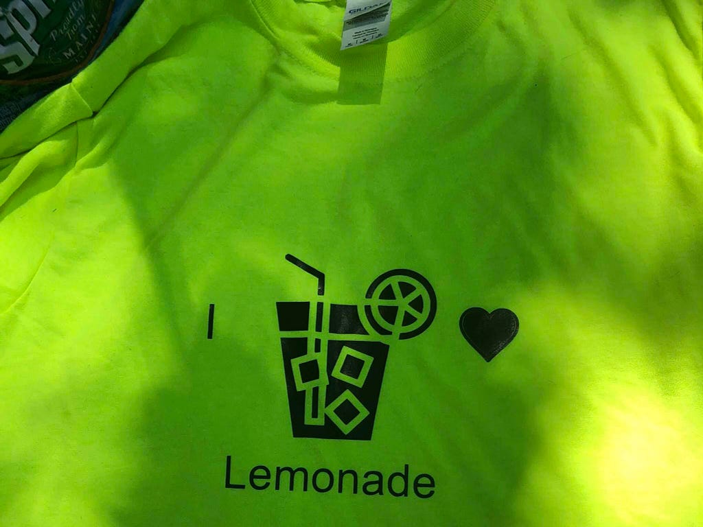 Photo of a custom t-shirt printing design that uses a Noun Project icon of a glass of lemonade
