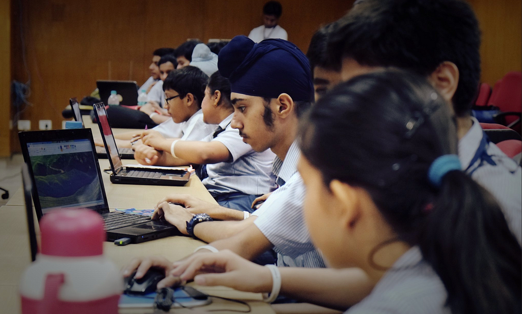 Young students working on laptops in a classroom