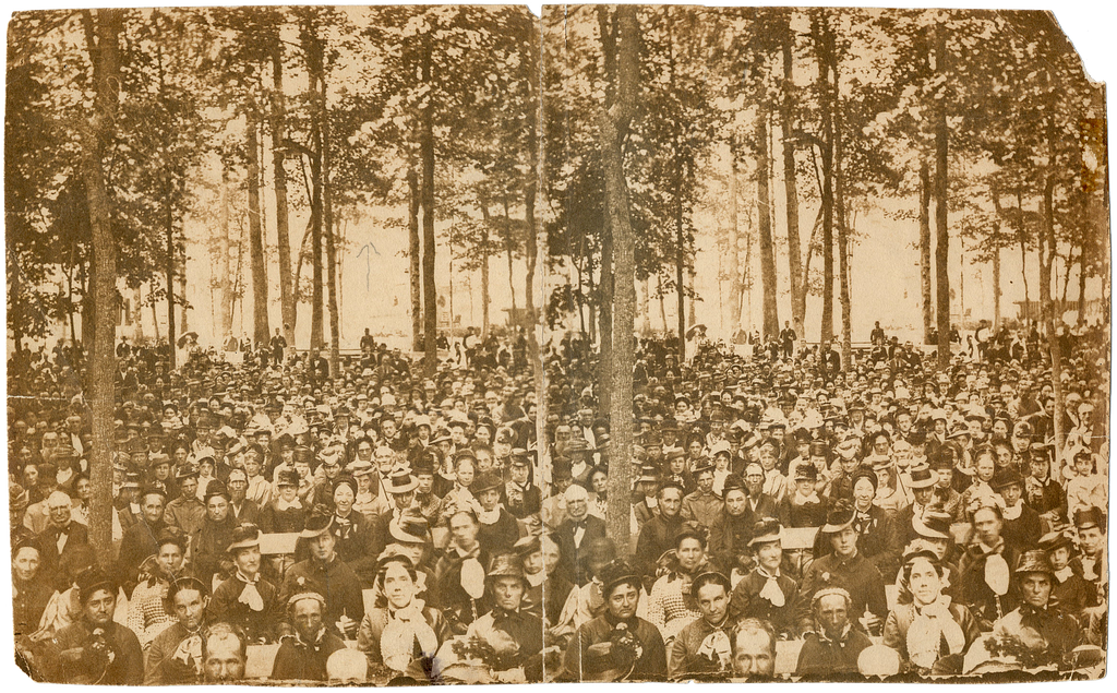 A largely female audience gathers for programming on the Chautauqua grounds in the late 19th century