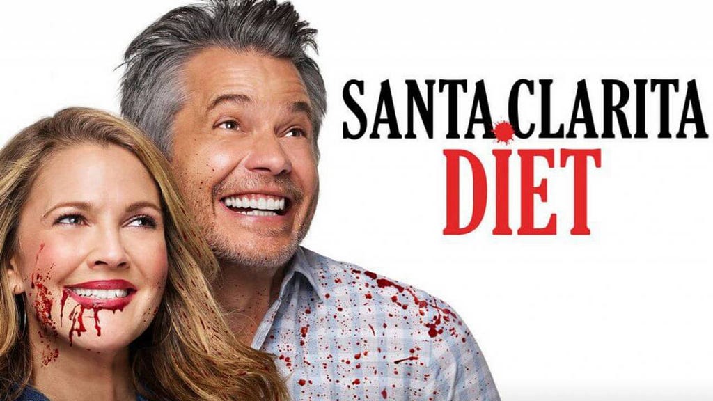 A close-up shot of a couple with the words Santa Clarita Diet next to them. The woman has blood dripping from her mouth while the man has blood spray on his shoulder and chest.